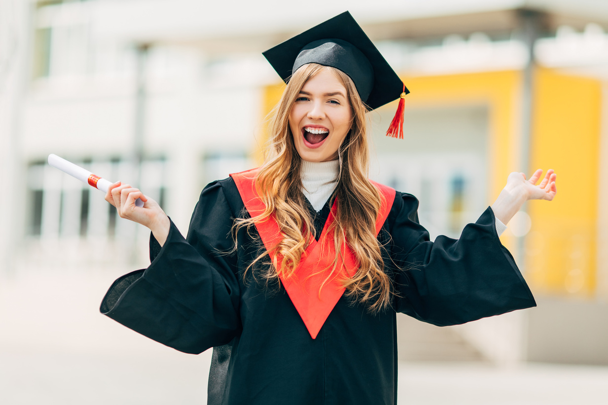 Happy Excited Beautiful Student with a University Degree, Shows a Victory Gesture and Rejoices. Concept of the Graduation Ceremony